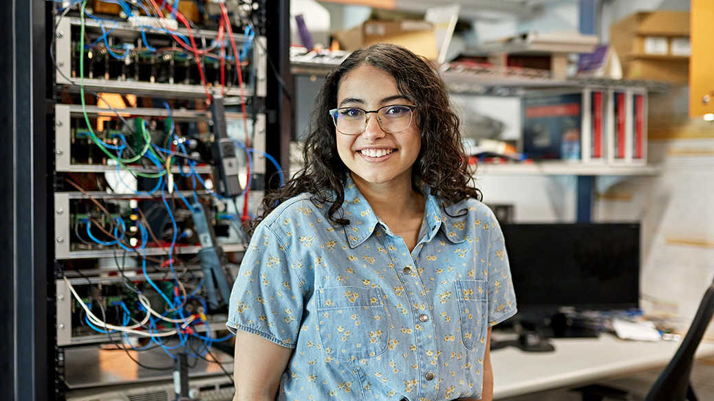 Person smiling into the camera in a data communications setting