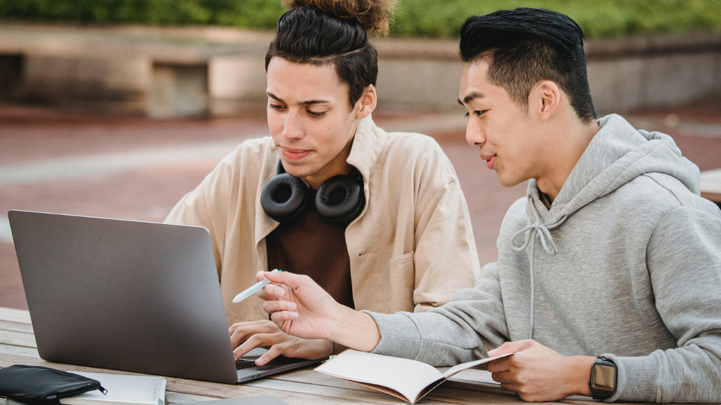Two people using a laptop together
